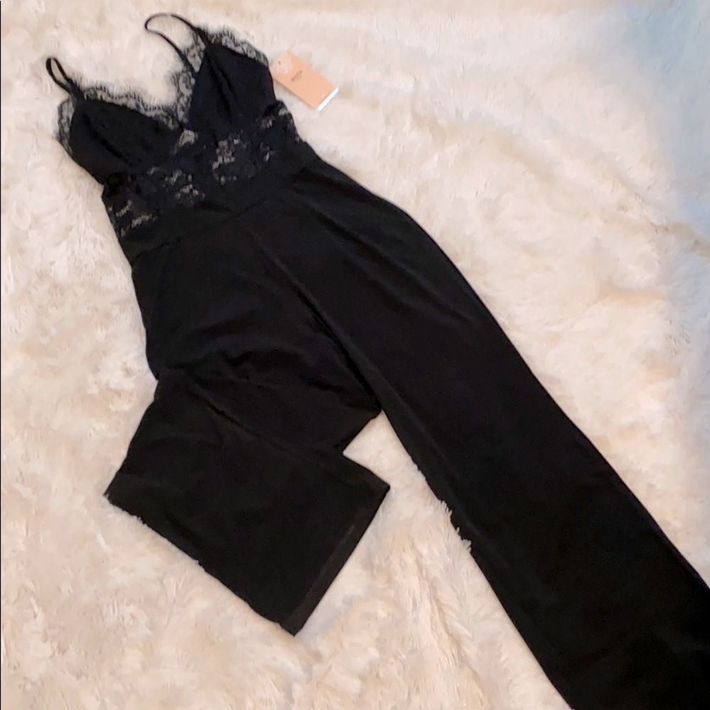 Brand new black strapped jumpsuit.